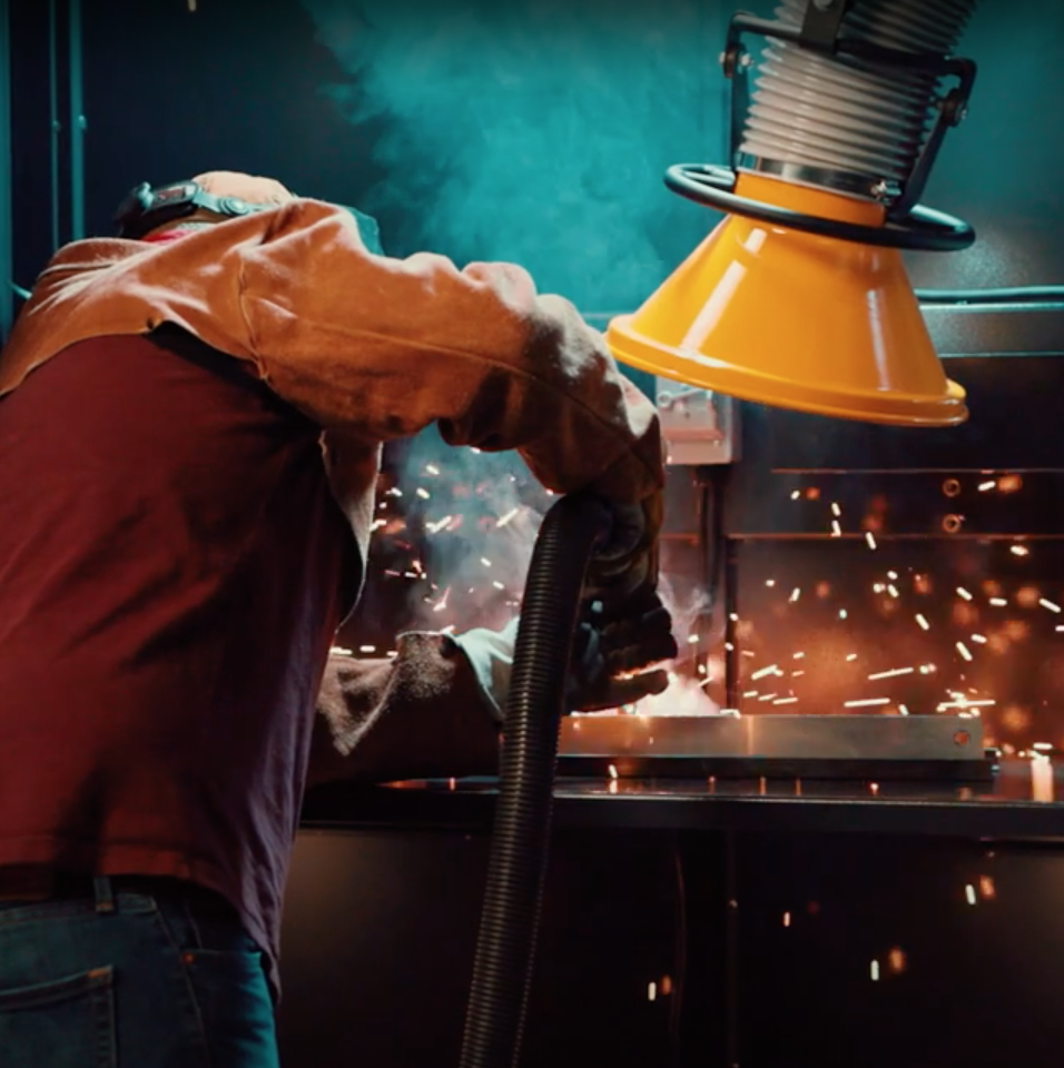 Fume extractor arm capturing welding smoke at the source to protect workers from hazardous fumes and improve air quality. Fume extractor arm capturing welding smoke at the source to protect workers from hazardous fumes and improve air quality.